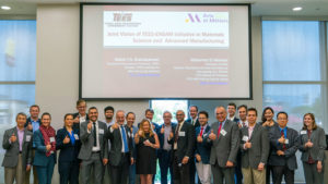 Group of professionals taking a picture in front of slide with words of Joint Vision of TEES-ENSAM Initiative in Materials Science and Advanced Manufacturing