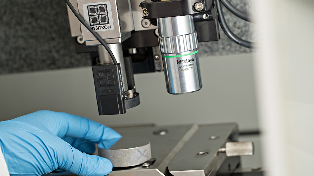 researcher using a Hysitron machine in a lab